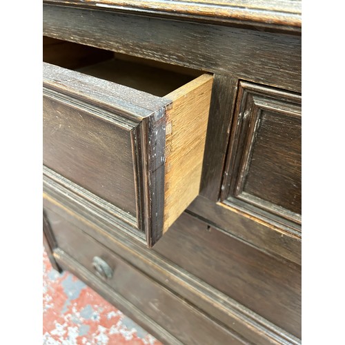 127 - An early 20th century oak chest of two short over two long drawers