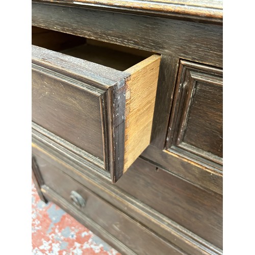 127 - An early 20th century oak chest of two short over two long drawers