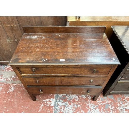 129 - An early/mid 20th century oak chest of three drawers