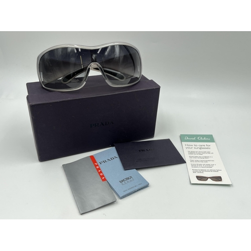 2394 - A boxed pair of Prada SPS 11G shield women's sunglasses