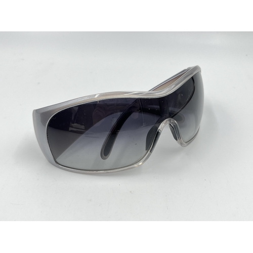 2394 - A boxed pair of Prada SPS 11G shield women's sunglasses