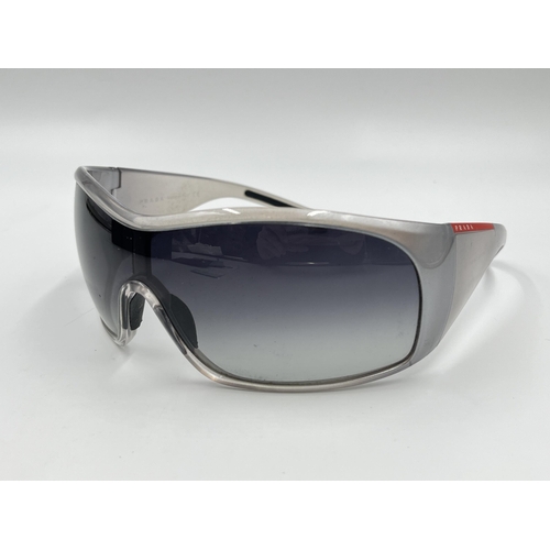 2394 - A boxed pair of Prada SPS 11G shield women's sunglasses