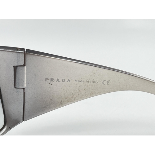 2394 - A boxed pair of Prada SPS 11G shield women's sunglasses