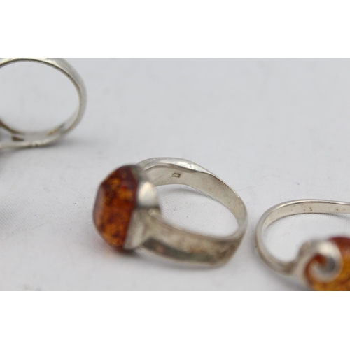 2167 - Five .925 silver amber rings - approx. gross weight 21g