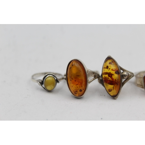 2167 - Five .925 silver amber rings - approx. gross weight 21g