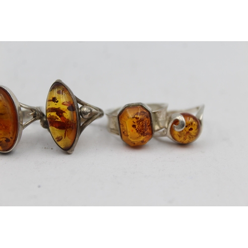 2167 - Five .925 silver amber rings - approx. gross weight 21g