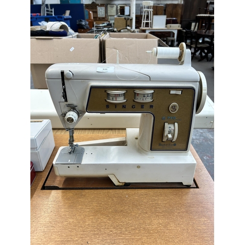 639 - A sewing machine cabinet containing Singer 720 touch and sew electric sewing machine with foot pedal... 