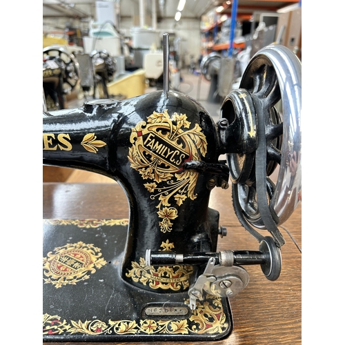 640 - A vintage sewing machine table fitted with Jones Family C.S. Sewing Machine