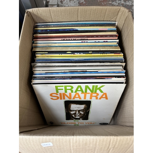 921 - Ten boxes containing a large collection of vinyl records, CDs and cassette tapes