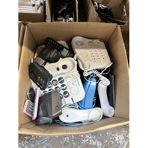 933 - Four boxes containing land line telephones, boxed mini sewing machine, coffee maker etc.