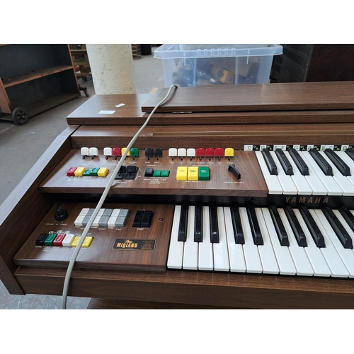 568A - A Yamaha Electone A-55N electric organ with stool