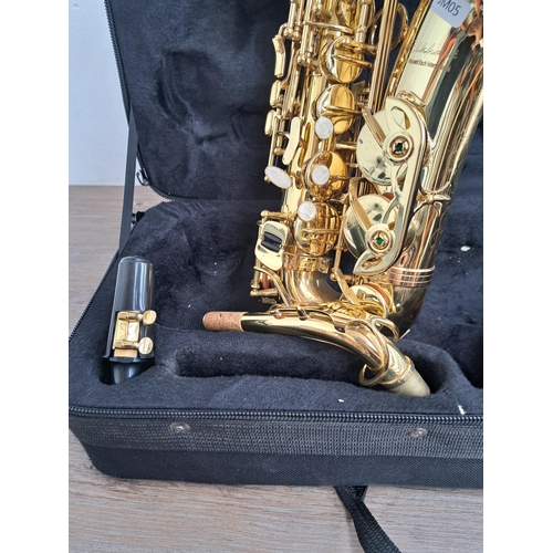 572 - A cased Vincent Bach International Elkhart alto saxophone with mouthpiece and strap