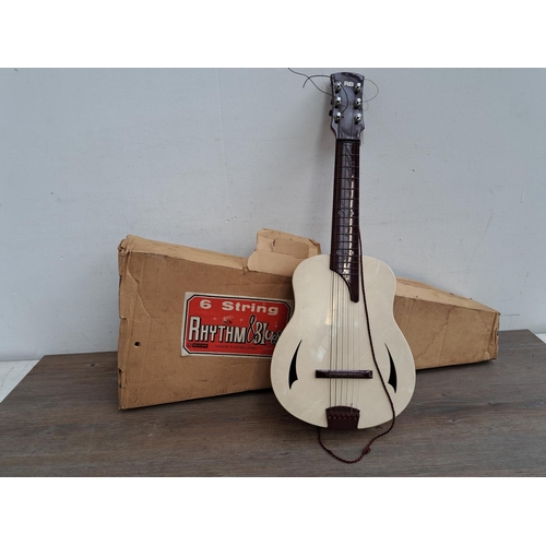 575 - A  boxed vintage Selcol 1005 plastic child's steel strung guitar (scale length 43cm)