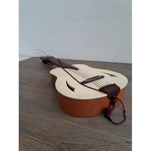 575 - A  boxed vintage Selcol 1005 plastic child's steel strung guitar (scale length 43cm)