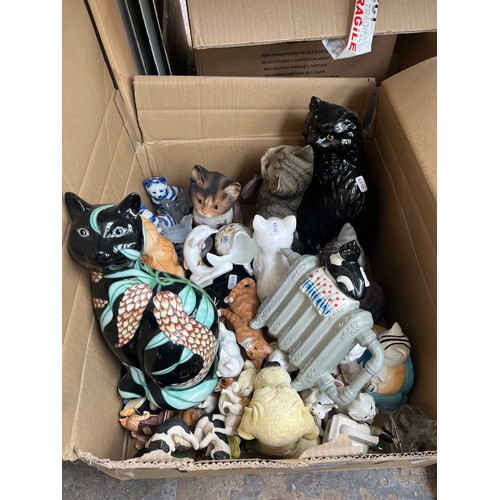 904 - A box containing ceramics and glassware to include Country Artists Inspirations cat figurine, cat on... 