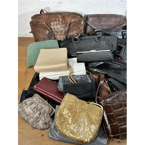 432 - A collection of women's bags to include early 20th century crocodile skin, Radley etc.