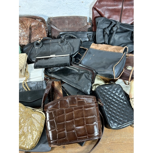 432 - A collection of women's bags to include early 20th century crocodile skin, Radley etc.