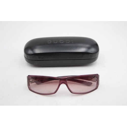 2439 - A pair of cased Gucci purple sunglasses