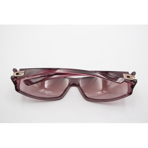 2439 - A pair of cased Gucci purple sunglasses