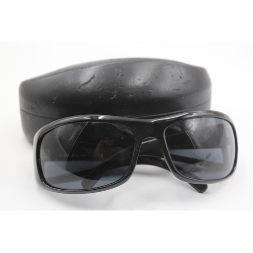 2441 - A pair of cased Prada black oversized sunglasses