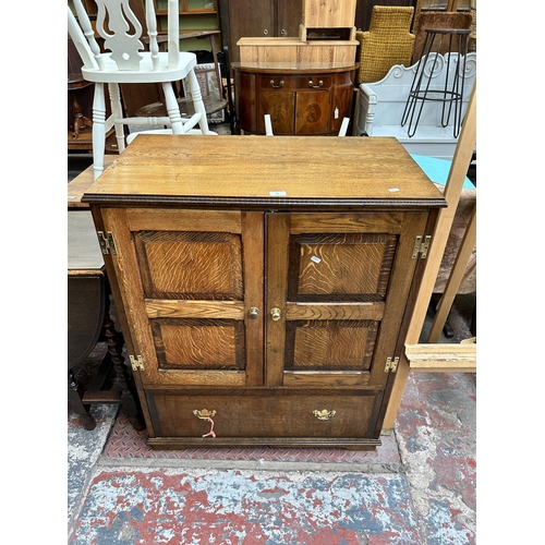 65 - A Georgian style oak TV cabinet with two doors and single drawer