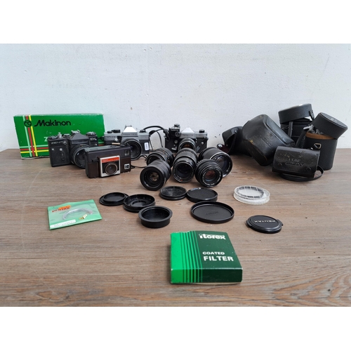 602 - A collection of cameras, lenses and cases to include Yashica J-P camera, Praktica MTL5B, one Zenit E... 