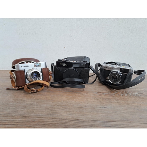 605 - Three cased cameras, one Yashica MG-1, one Olympus Trip 35 and one boxed Voigtländer Veto B