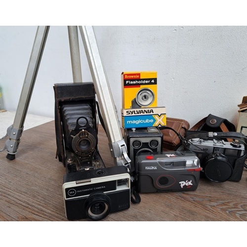 606 - A large collection of optical instruments and accessories to include Fujica MP camera, Yashica Zoomt... 