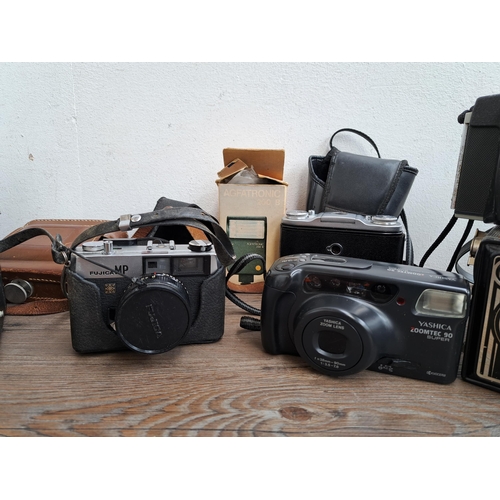 606 - A large collection of optical instruments and accessories to include Fujica MP camera, Yashica Zoomt... 