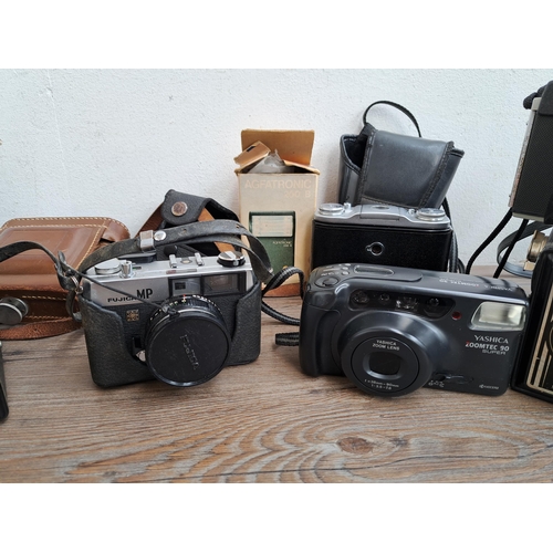 606 - A large collection of optical instruments and accessories to include Fujica MP camera, Yashica Zoomt... 