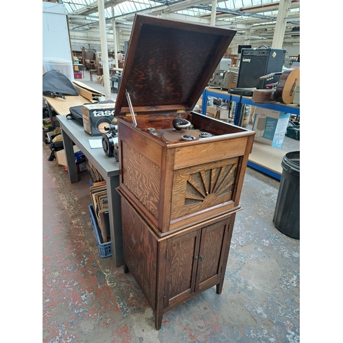 634 - A pine gramophone unit and cabinet containing various accessories and records