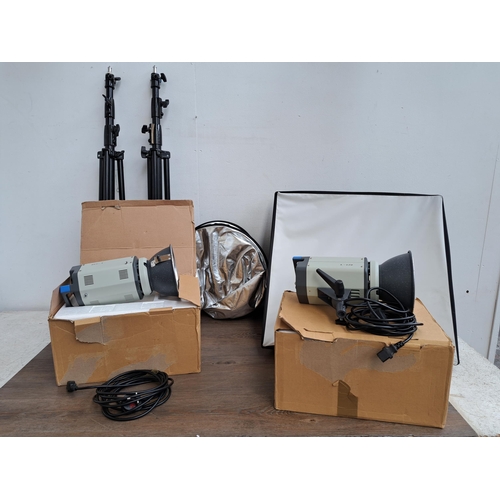 638 - A collection of photography equipment to include two boxed L-120 lights, two tripods, a projection s... 