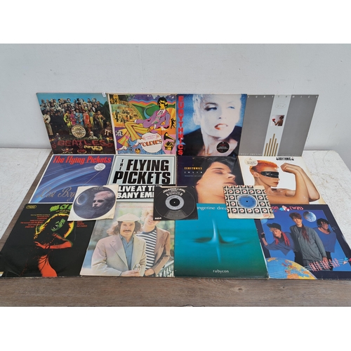 642 - A collection of vinyl records to include The Beatles, Eurythmics, Tangerine Dream, Kate Bush etc.