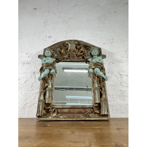 251 - An Alan Wallis Designs hand made plaster wall mirror with cherub design - approx. 67cm high x 50cm w... 