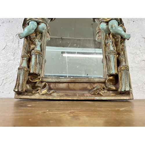 251 - An Alan Wallis Designs hand made plaster wall mirror with cherub design - approx. 67cm high x 50cm w... 