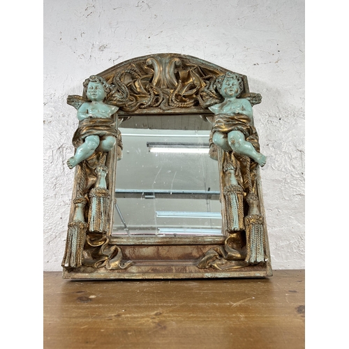 251 - An Alan Wallis Designs hand made plaster wall mirror with cherub design - approx. 67cm high x 50cm w... 