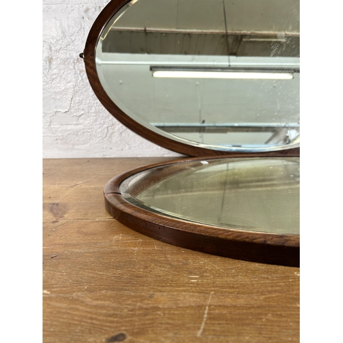 270A - Two early 20th century wooden framed bevelled edge oval wall mirrors, one oak and one mahogany