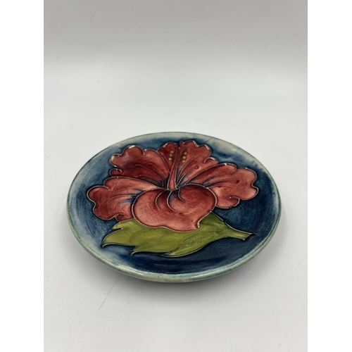 302 - A Moorcroft Hibiscus pattern circular trinket dish - approx. 12cm diameter