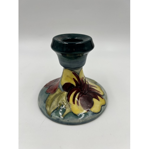 303 - A Moorcroft Hibiscus pattern candlestick - approx. 8.5cm high