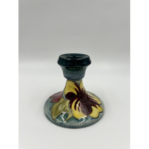 303 - A Moorcroft Hibiscus pattern candlestick - approx. 8.5cm high