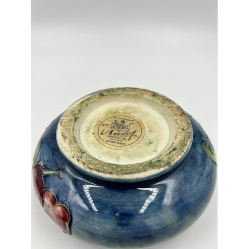 304 - A Moorcroft Hibiscus pattern circular lidded trinket box - approx. 12cm diameter