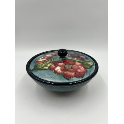 306 - A Moorcroft Clematis pattern circular lidded bowl - approx. 16cm diameter