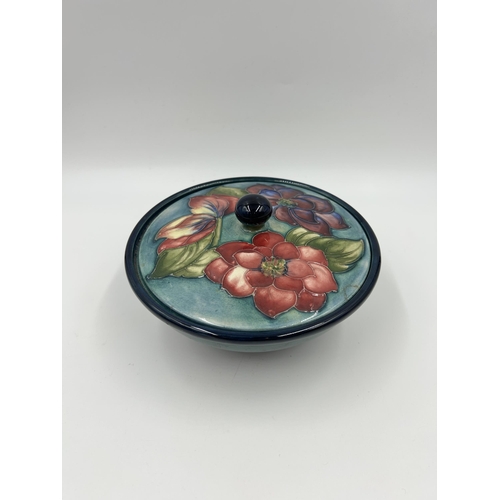 306 - A Moorcroft Clematis pattern circular lidded bowl - approx. 16cm diameter