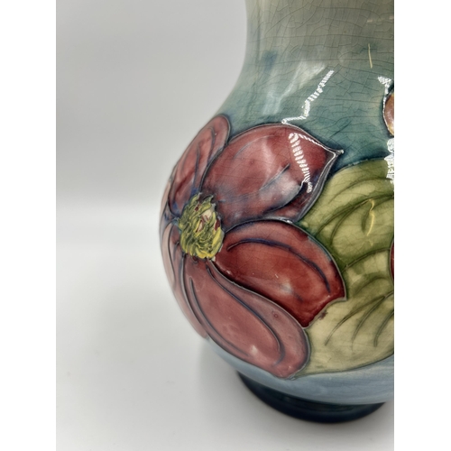 307 - A Moorcroft Clematis pattern vase - approx. 19cm high