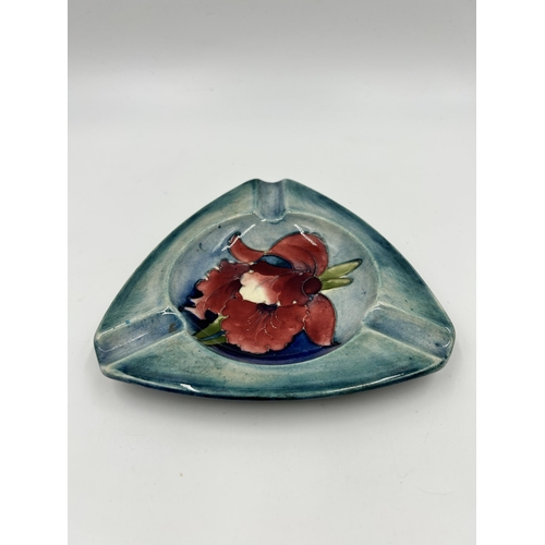 308 - A Moorcroft Hibiscus pattern triangular ashtray - approx. 14cm diameter