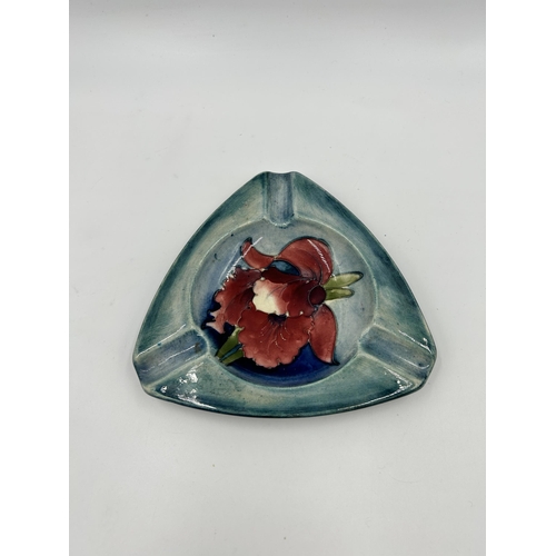 308 - A Moorcroft Hibiscus pattern triangular ashtray - approx. 14cm diameter