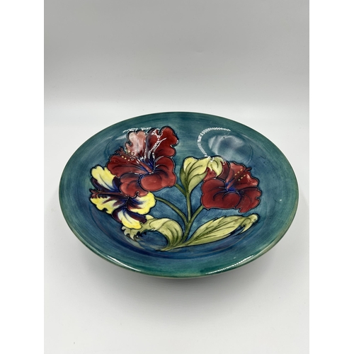 309 - A Moorcroft Hibiscus pattern circular footed bowl - approx. 25cm diameter