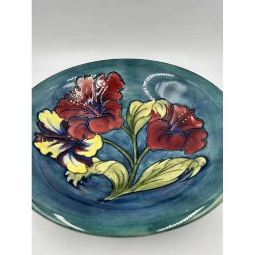 309 - A Moorcroft Hibiscus pattern circular footed bowl - approx. 25cm diameter