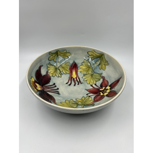 311 - A Moorcroft Columbine pattern circular footed bowl - approx. 27cm diameter