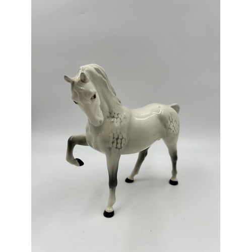 329 - A Beswick no. 1549 head tucked leg up grey horse figurine